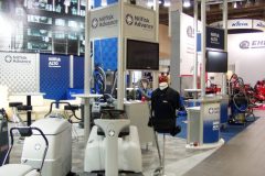 Stoisko wystawowe prezentujące maszyny i urządzenia czyszczące Nilfisk Advance, z banerami, wyświetlaczami produktów i znakami informacyjnymi w hali kongresowej. projekt i nadzór Tatjana Kobuszewska trksystem.com