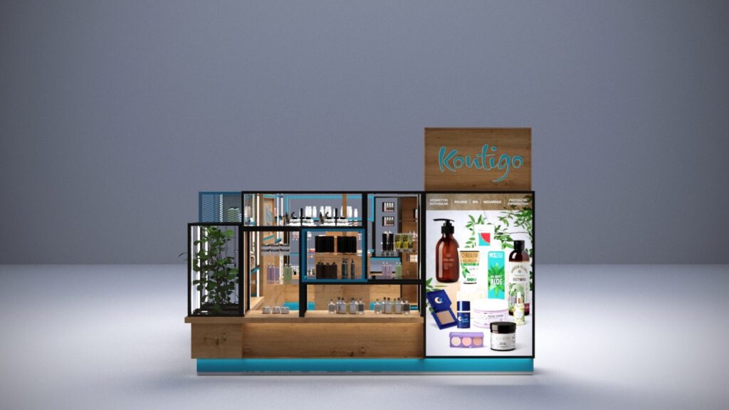 Nowoczesny drewniany kiosk handlowy, zaprojektowany jako wyspa handlowa, prezentuje na szklanych półkach kosmetyki do pielęgnacji urody i skóry. Uwagę przyciągają podświetlony blat oraz napis „Koutigo”, natomiast na prawym panelu umieszczono zdjęcia produktów oraz elementy zieleni pełniące rolę dekoracyjną. projekt i nadzór Tatjana Kobuszewska