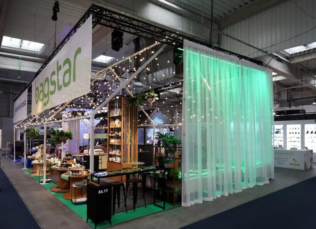 Stoisko Bagstar na targach Eurogastro — projekt autorstwa pracowni TRK System zachwyca nowoczesnym designem: łańcuchy świetlne, zielone akcenty, drewniane ekspozytory i rośliny. Przestronne i otwarte stoisko w jasnej hali przyciąga wzrok gości. projekt i nadzór Tatjana Kobuszewska